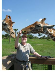 Robert Scheer feeding giraffes