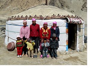 Family at yurt by lake karakul china