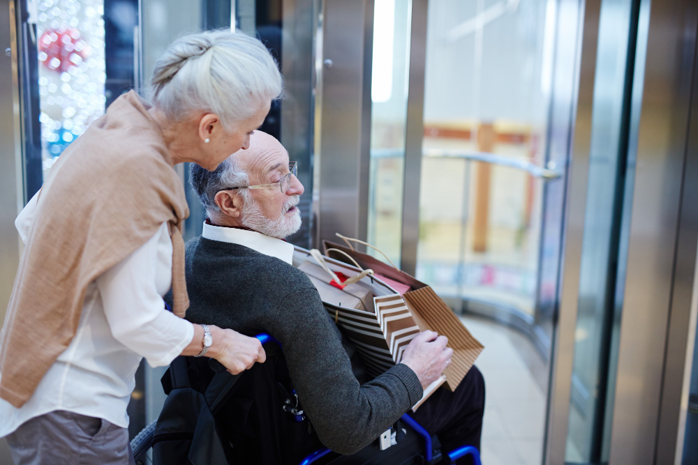 Woman helping man in wheelchair